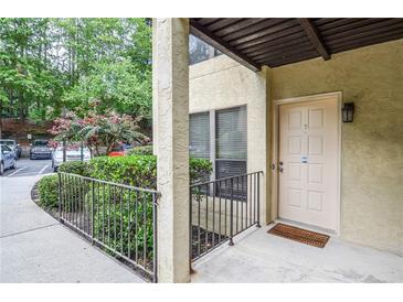 Inviting condo entrance with private door and well-manicured landscaping at 407 Coleraine Se, Smyrna, GA 30080