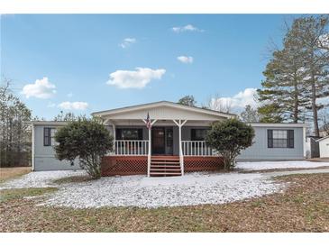 Ranch-style home with covered porch and landscaped yard at 1265 Glenbrooke Cv, Lawrenceville, GA 30045