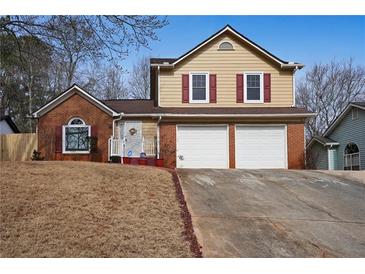 Two-story house with a two-car garage and a neatly landscaped yard at 3815 Landgraf Cv, Decatur, GA 30034