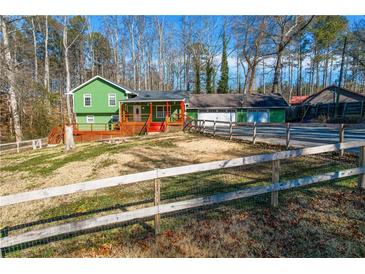 Ranch home with green siding, deck, and detached garage at 5912 Jacobs Rd, Acworth, GA 30102