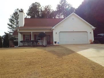 Charming one-story house with a red roof, white siding, and a two-car garage at 115 The Falls Blvd, Covington, GA 30016