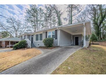 Gray brick ranch home with carport and landscaped yard at 1937 Windsor Sw Dr, Atlanta, GA 30311