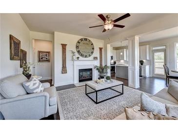 Spacious living room features a cozy fireplace and large windows at 1934 Asher Ln # 060, Conyers, GA 30013