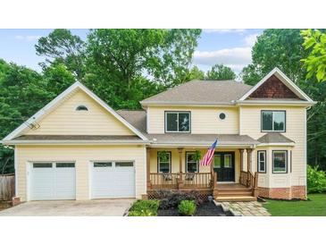 Two-story house with a large front porch and attached two-car garage at 2010 Sturbridge Ln, Buford, GA 30519