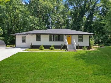 Charming ranch home with a freshly landscaped lawn and modern updates at 4291 Lamar St, Decatur, GA 30035