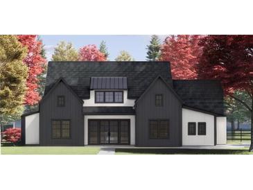 Two-story farmhouse with black and white exterior, and a pitched roof at 115 Palisade Dr, Rydal, GA 30171