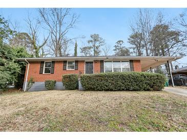 Charming brick home featuring a well-maintained lawn and a convenient carport at 1820 Arkose Dr, Atlanta, GA 30316