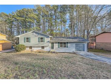 Ranch style home with gray siding, attached garage, and mature trees at 2536 Nw Ridgecrest Nw Dr, Kennesaw, GA 30152