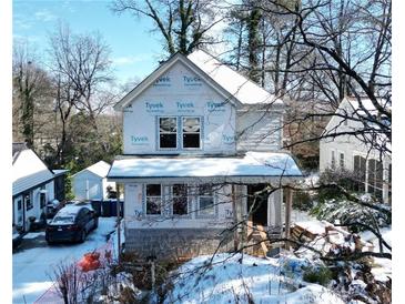 Snow-covered house under construction, wrap installed, new build at 2486 Jefferson Ter, Atlanta, GA 30344
