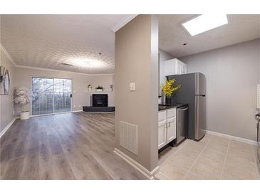 Open concept kitchen and living room with stainless steel appliances and fireplace at 970 Sidney Marcus Ne Blvd # 2113, Atlanta, GA 30324