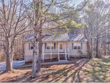 Ranch home with front porch, situated on a wooded lot at 396 Southern Trace Dr, Rockmart, GA 30153