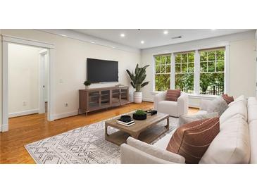 Bright living room featuring hardwood floors, lots of natural light, and contemporary furnishings at 273 12Th Ne St # 210, Atlanta, GA 30309