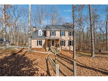 Two-story brick home with a charming front porch and landscaped yard at 5120 Due West Nw Rd, Kennesaw, GA 30152