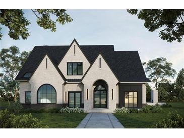 Stunning two-story home with a brick facade, black roof, and arched entryway at 381 Canton St, Alpharetta, GA 30009