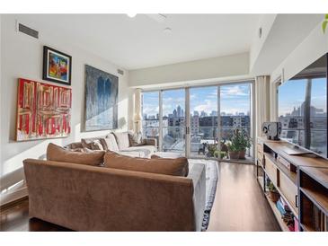 Spacious living room with city views and hardwood floors at 1100 Howell Mill Nw Rd # 610, Atlanta, GA 30318