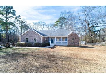 Charming single-story brick home with a welcoming front porch and well-maintained lawn at 4801 Daniel Mill Rd, Winston, GA 30187