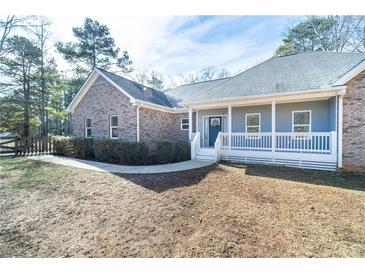 Charming single-story home featuring a brick facade, covered front porch, and well-maintained landscaping at 4801 Daniel Mill Rd, Winston, GA 30187