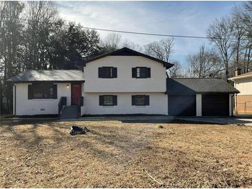 Charming two-story home with white painted brick and a well-maintained front yard at 2715 Heritage Ln, Morrow, GA 30260