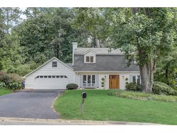 Charming home with a well-manicured lawn, mature trees, and a welcoming, classic facade at 5371 Tall Oak Dr, Marietta, GA 30068