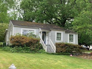 Charming gray house with stone steps, surrounded by lush landscaping at 2771 Georgian Dr, Brookhaven, GA 30341