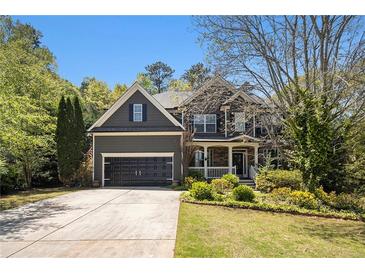 Charming two-story home with a well-manicured lawn, two car garage and inviting front porch at 120 Fountain Oak, Villa Rica, GA 30180