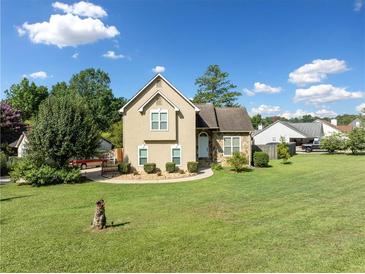 Tan house with stone accents, landscaped yard, and a driveway at 1131 Orr Rd, Jonesboro, GA 30238