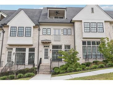 Stunning townhome exterior featuring brick detailing and a charming front porch at 6829 Crescendo Ct, Atlanta, GA 30328