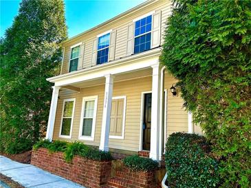 Charming two-story home featuring a welcoming front porch with white columns and well-maintained landscaping at 3236 Tallon Sw Ln, Atlanta, GA 30311