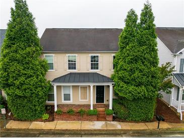 Charming two-story home with manicured front yard and inviting entrance and green trees at 3236 Tallon Sw Ln, Atlanta, GA 30311