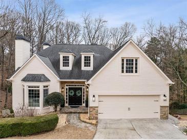 Charming single-Gathering home featuring a well-manicured lawn and a two-car garage at 3730 Ashford Ne Pt, Brookhaven, GA 30319