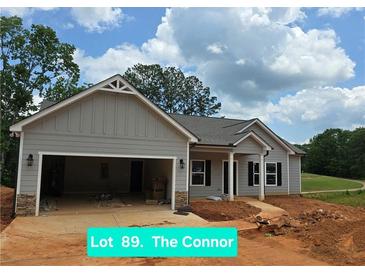 Charming single-story home with gray siding, stone accents, and an attached two-car garage in a residential area at 8970 Callaway Dr, Winston, GA 30187