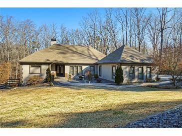 Stunning ranch home with inviting front porch and manicured lawn at 201 Windflower Ct, Canton, GA 30115