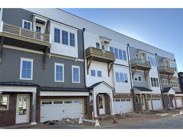 New townhome exteriors with garages, balconies and craftsman details create a warm and welcoming neighborhood at 4213 Legacy Ln # 32, Acworth, GA 30101