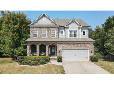 Two-story house with stone accents and a landscaped yard at 520 Andes Ln, Canton, GA 30114