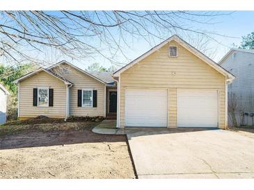 House exterior featuring a two-car garage and neutral siding at 515 Allens Landing Ct, Lawrenceville, GA 30045