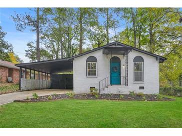 Charming renovated brick ranch home with a covered carport and landscaped lawn at 2060 Westwood Ave, Atlanta, GA 30310