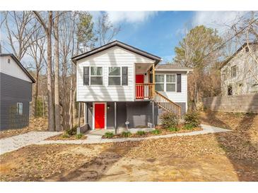 Newly renovated house with gray and white exterior, red door, and a small deck at 2343 Carver Nw Dr, Atlanta, GA 30314