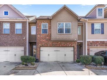 Brick front townhouse with 2-car garage and landscaping at 4029 Fireoak Dr, Decatur, GA 30032