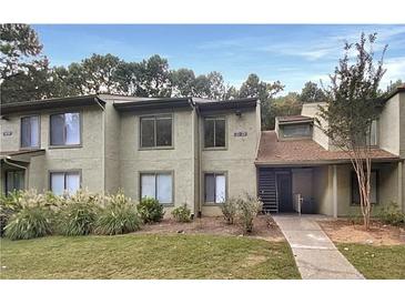 Attractive exterior of a condo building with landscaping and a walkway at 224 Seasons Pkwy, Norcross, GA 30093