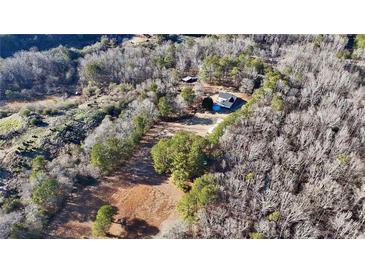 An aerial view of the home and surrounding wooded acreage, showcasing its secluded location and outdoor space at 4320 Center Hill Church Rd, Loganville, GA 30052