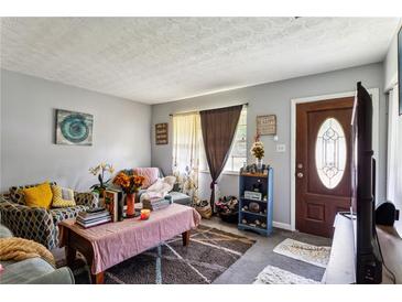 Cozy living room featuring comfy sofas, a coffee table, and decorative accents at 792 Plainville Sw Cir, Atlanta, GA 30331