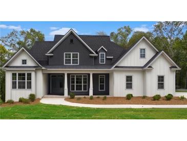 Two-story farmhouse with gray and white exterior, landscaped lawn at 152 Palisade Dr, Rydal, GA 30171