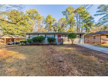 Charming one-story home with a well-maintained front yard, mature trees, and brick accents at 3080 Santa Monica Dr, Decatur, GA 30032