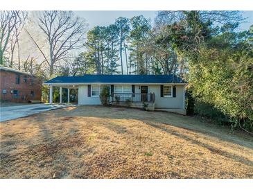 Charming single-story home with a covered carport and a well-maintained front yard at 1927 Cindy Dr, Decatur, GA 30032
