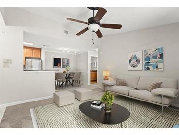 Spacious living room features a ceiling fan, neutral colors, and an open floor plan at 534 Granville Ct, Atlanta, GA 30328