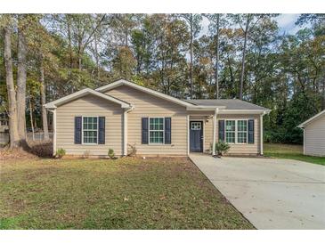 Newly built home with gray siding, gray shutters, and a gray door at 7133 Pineview Sw Dr, Covington, GA 30014