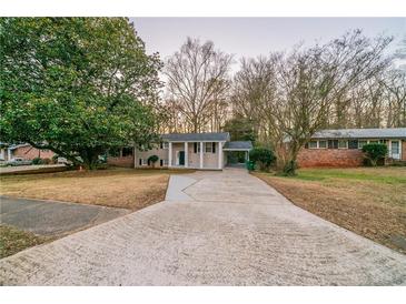 Inviting single Gathering home featuring a long driveway and covered carport at 3401 Tulip Dr, Decatur, GA 30032