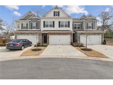 Three-unit townhome building with attached garages and landscaping at 5857 Silver Lake Dr, Mableton, GA 30126