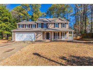 Two-story house with attached garage and front porch at 2022 Portsmouth Ct, Lawrenceville, GA 30044