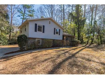 Ranch home with stone accents and a spacious yard at 8652 Embrey Dr, Jonesboro, GA 30236